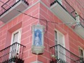 The santos on Calle Cuatro Santos adorn many buildings.