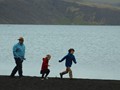We walked along Kleifarvatn, happy to be out of the airplane. There were cars parked on the black sandy shore.