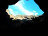 Light peeking through a cave roof collapse.