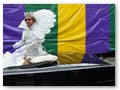 The king of the all-female Krewe of Iris always rides in a convertable.
