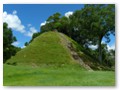 The mound at Altun Ha, still covered in grass and dirt.